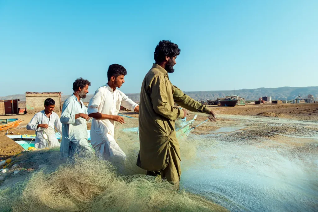 Fisherman Holding Fishing Net Near The Beach